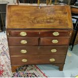 Georgian Mahogany Bureau, the fall front opening to an arrangement of drawers and compartments, over