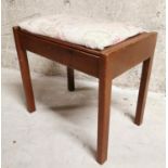 Upholstered piano stool.