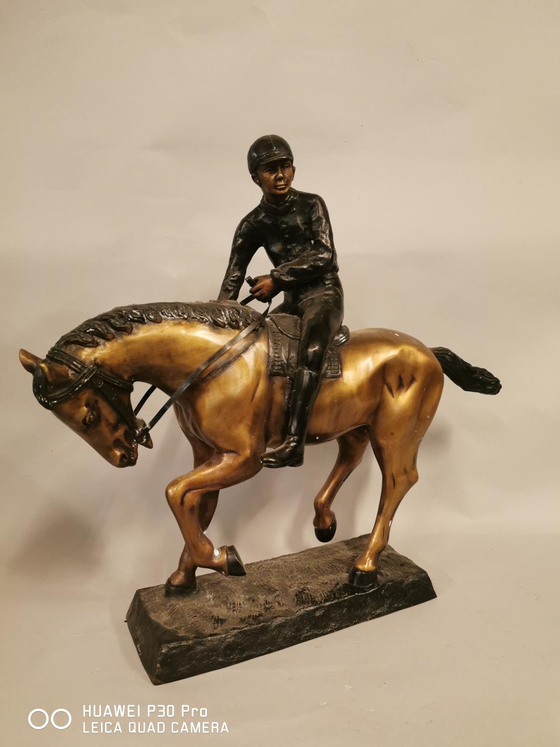 Model of a bronze jockey and horse.