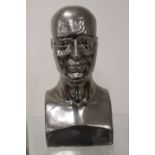 White metal bust of a man.