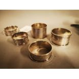 Five English silver napkin rings.