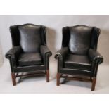 Pair of Edwardian leather wing back chairs.