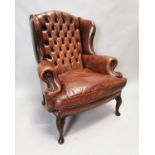 Hand dyed leather wing back armchair.