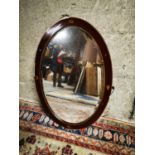 Edwardian inlaid mahogany oval wall mirror.