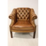 Deep buttoned leather armchair.