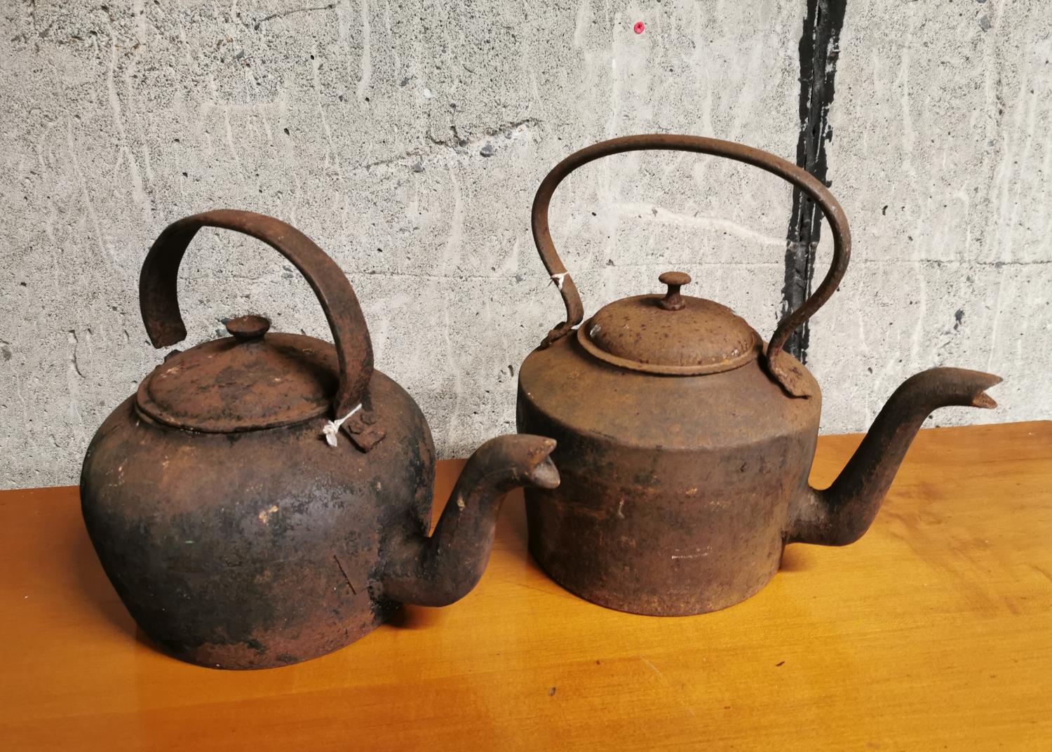 Two cast iron kettles.