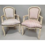 Near pair of painted pine and upholstered armchairs.