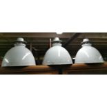 Set of three 1940s enamel light shades.