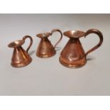 Set of three graduated copper measures.