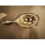 English silver tea strainer.