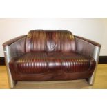 Good quality two seater aviator style couch.