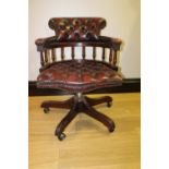 Deep buttoned leather upholstered captain's swivel chair.