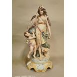 Ceramic figural group of a Maiden and Cherub.