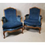 Pair of Edwardian carved walnut and upholstered armchairs.