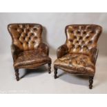 Pair of leather deep buttoned chairs.
