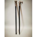 Two silver plate topped walking sticks.