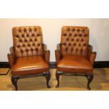 Pair of oak and leather arm chairs.