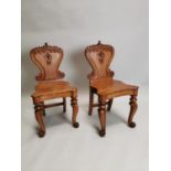 Pair of 19th C. carved oak hall chairs.