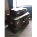 Three brown leather suitcases.