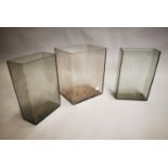 Set of three moulded glass vases.
