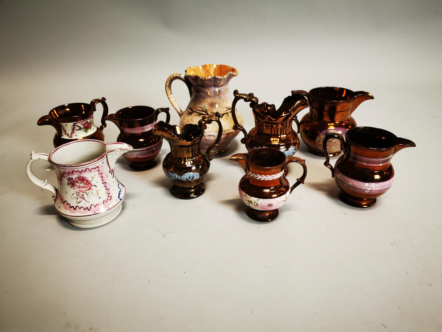 Collection of eight ceramic water jugs.