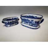Two blue and white ceramic foot baths.