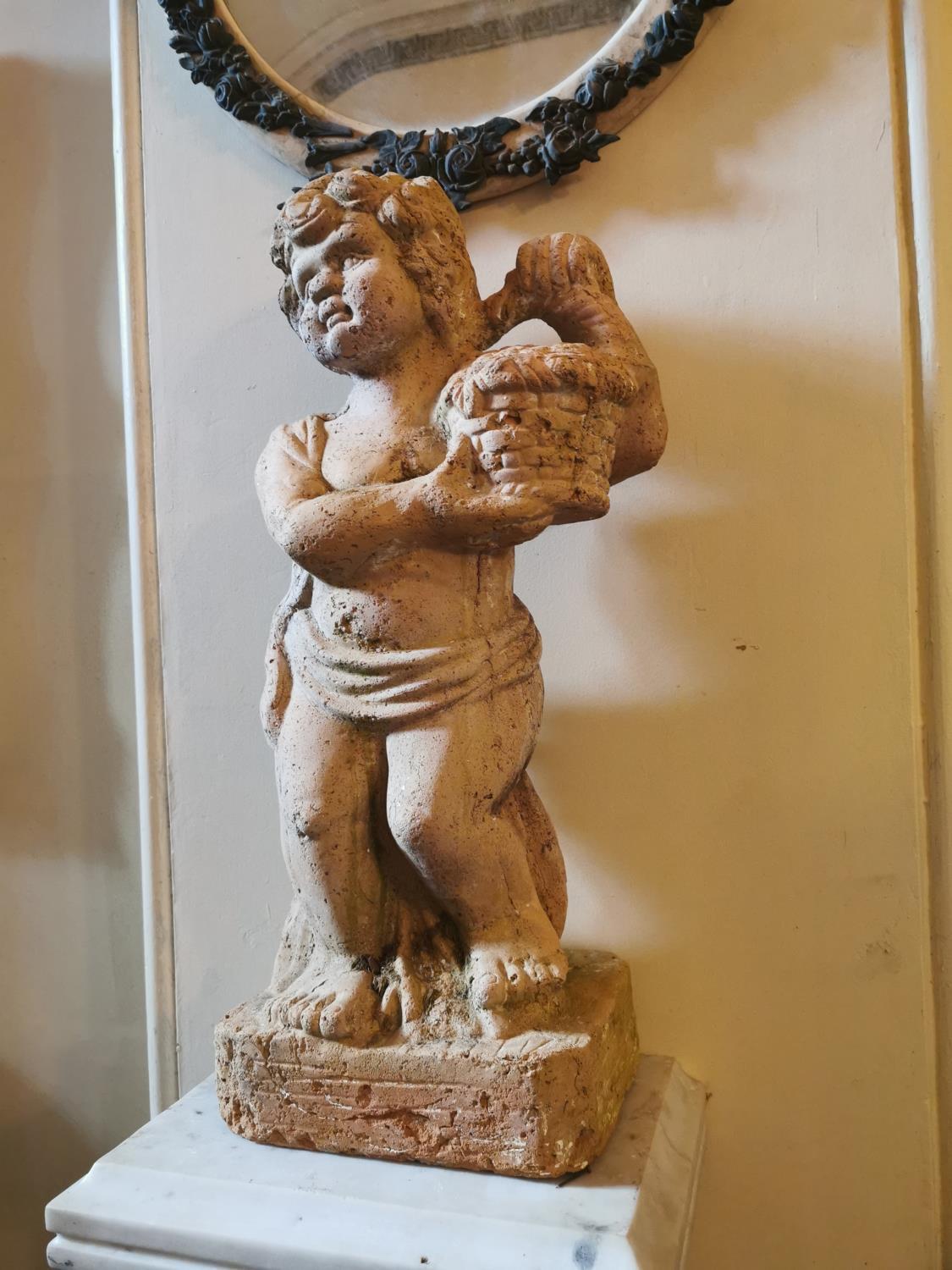 Pair of 19th. C. terracotta cherubs holding baskets.