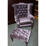 Upholstered wing back armchair and foot stool.