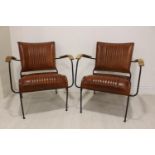 Pair of metal and leather easy chairs.