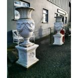 Pair of good quality cast stone urns.