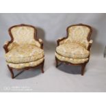 Pair of walnut and upholstered arm chairs.