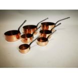 Set of seven graduated saucepans with metal handles