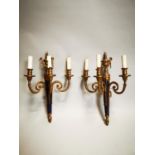 Pair of three branch brass wall sconces.