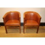 Pair of leather upholstered tub chairs.