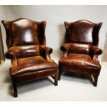 Pair of leather wingback armchairs.