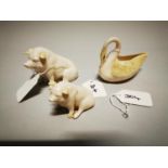 Two modern Belleek models of pigs and a swan.