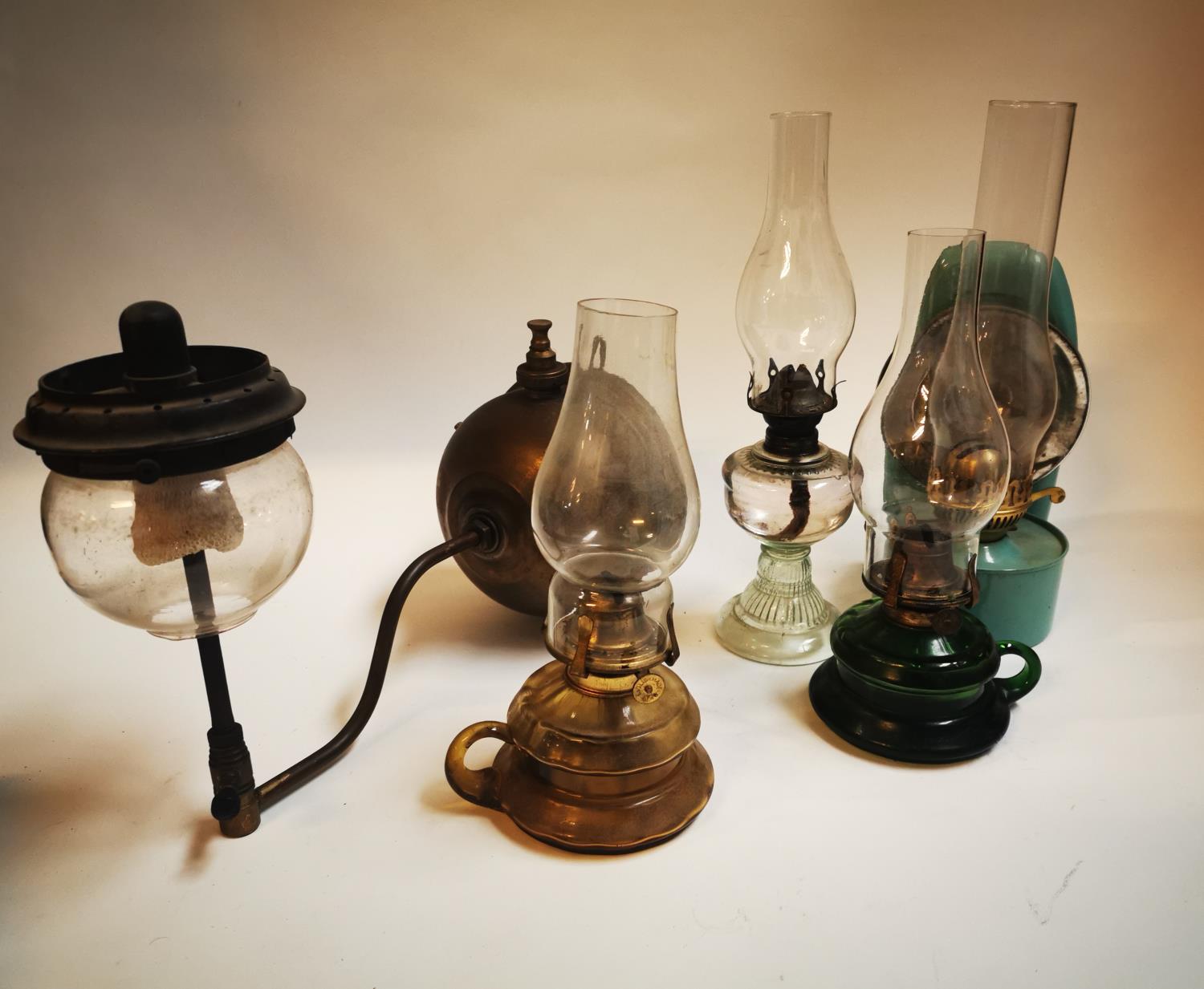 Collection of early 20th C. thumb lamps and a tilly lamp.