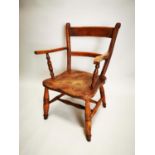 Early 20th C. elm open armchair.