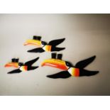 Three Guinness Flying Toucan figures.