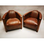 Pair of hand died leather and walnut Aviator chairs.