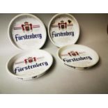 Four Furstenberg advertising drinks trays.