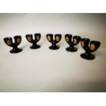 Set of five Guinness advertising egg cups.