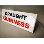 Draught Guinness advertising sign.