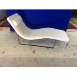 Designer lounger with leather head rest on chrome base.