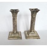Pair of Corinthian column silver plated candle sticks on square bases H 7''