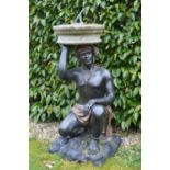 Bronze sundial of kneeling figure with a circular sandstone top and lead sundial W 42 H 110 D 42