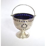 Pierced circular silver Classical design swing handle basket with blue glass liner. Chester 1915