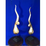 Pair of carved wood and gilded bird design objects on stripped bases W 15 H 106 D 19