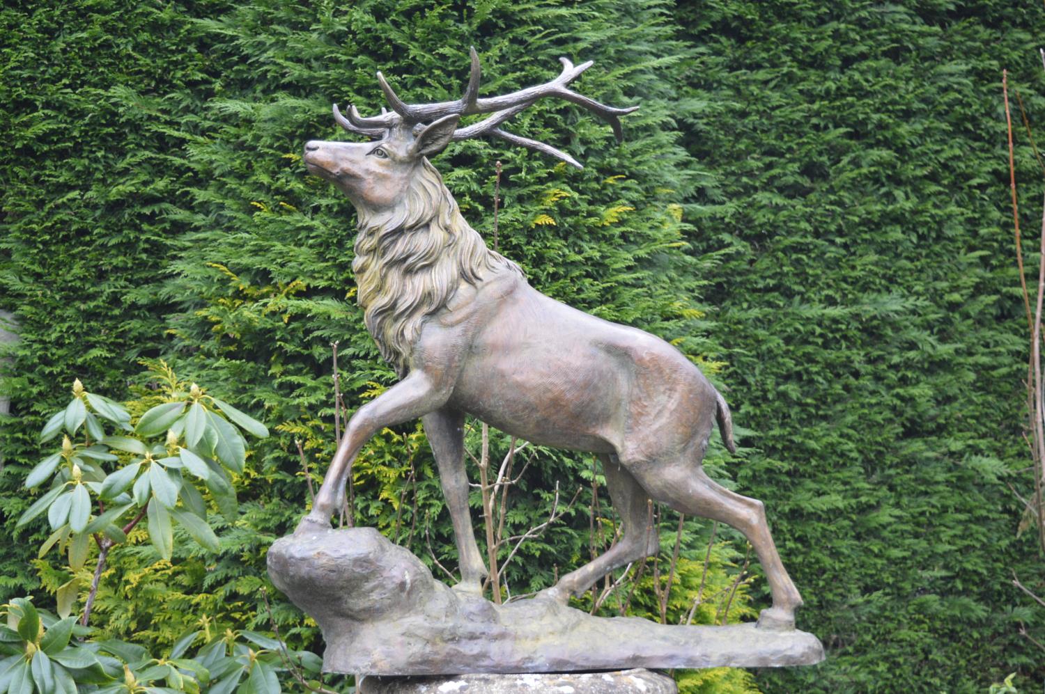 Bronze sculpture of a stag on rocky ground W 100 H 110 D 40