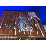 Large collection of cutlery including meat skewers and crab cutlery.